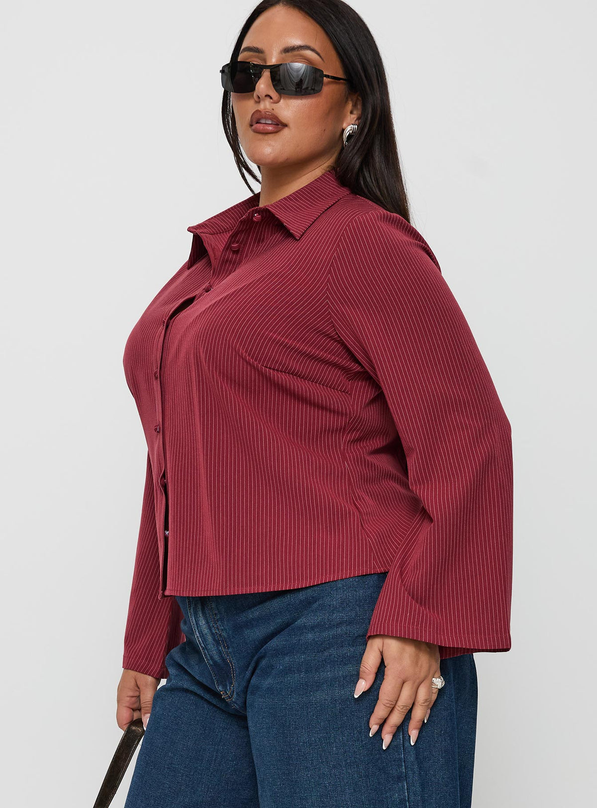 side view of model wearing Princess Polly Anni Pinstripe Shirt Red Curve Full Sleeves V-Neck 