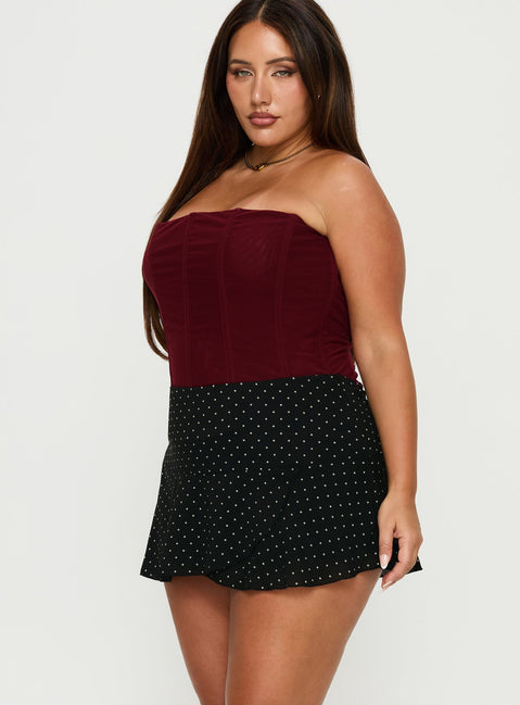   side view of model wearing Princess Polly Sonsie Mini Skirt Black / White Polka Curve Skirts 