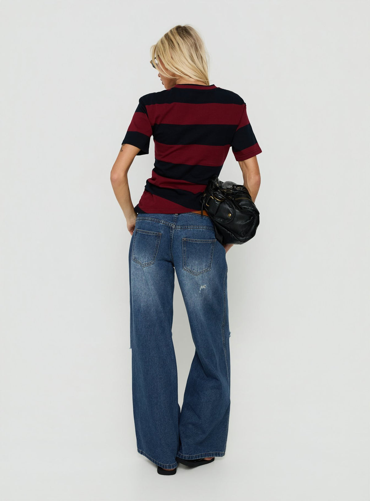 Presenting the Ramos Low Rise Double Button Distressed Wide Leg Denim Jeans in Mid Blue womens jeans back view of model wearing Princess Polly