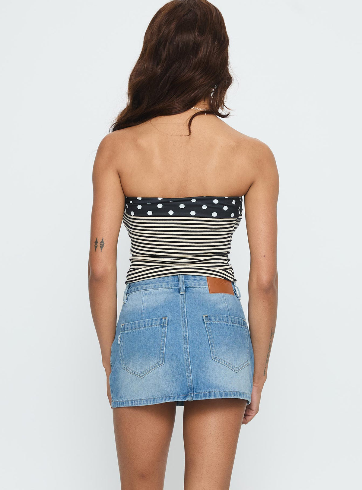 back view of model wearing Princess Polly Cailin Denim Mini Skirt Light Blue Wash Skirts 