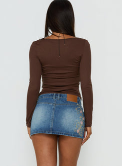 Showcasing the Flatline Embroidered Denim Mini Skirt Mid Wash in womens-skirts with mini length back view of model wearing