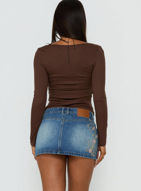 Showcasing the Flatline Embroidered Denim Mini Skirt Mid Wash in womens-skirts with mini length back view of model wearing