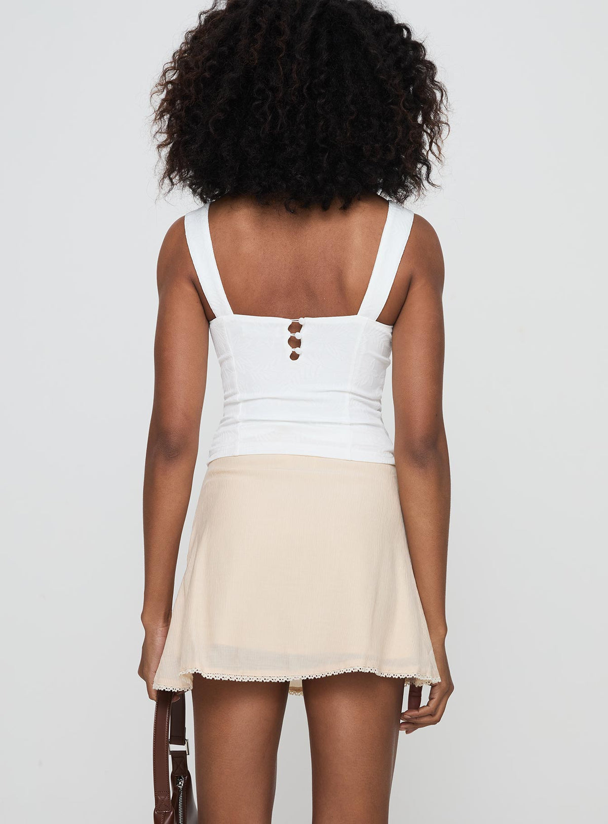 back view of model wearing Princess Polly Foalie Ruffle Mini Skirt Beige Mini Skirts Skirts 