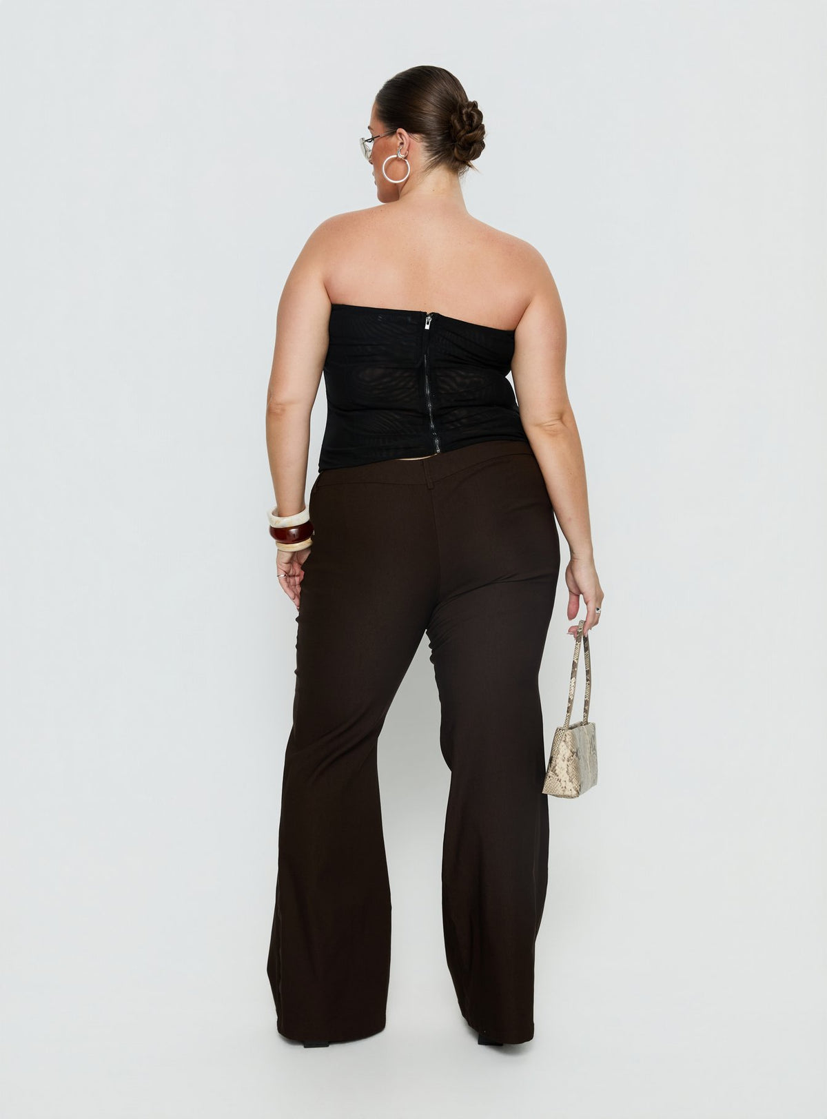 back view of model wearing Princess Polly Kinkirk Flared Pants Chocolate Curve Mid Rise Pants Pants 