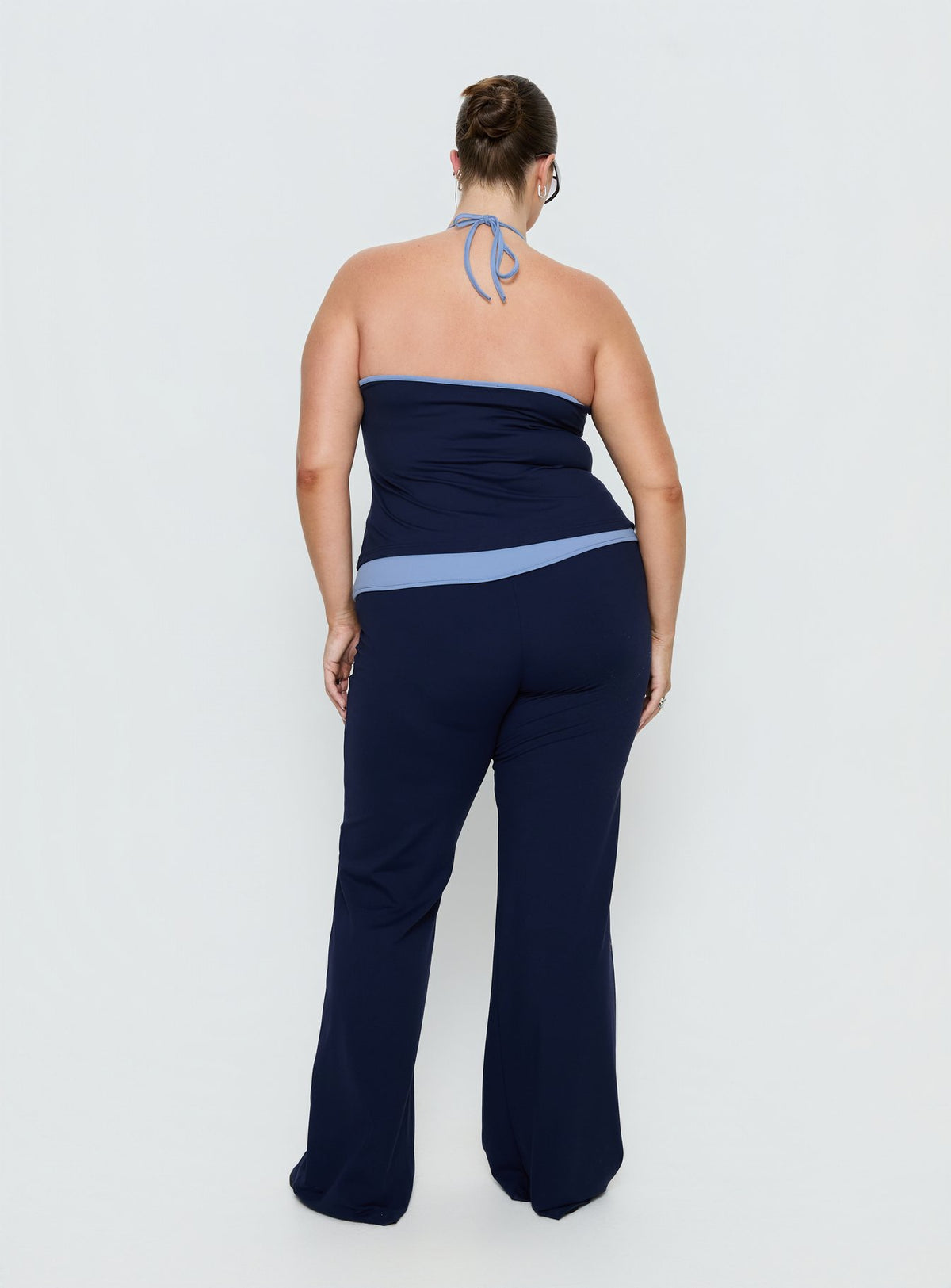 back view of model wearing Princess Polly Kobee Jersey Flare Pants Navy / Light Blue Curve High Rise Pants Pants 