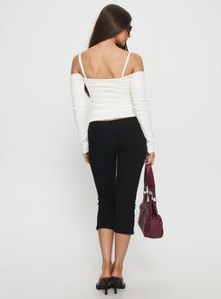 back view of model wearing Princess Polly Baseline Rib Capri Pants Black Petite Mid Rise Pants Pants 