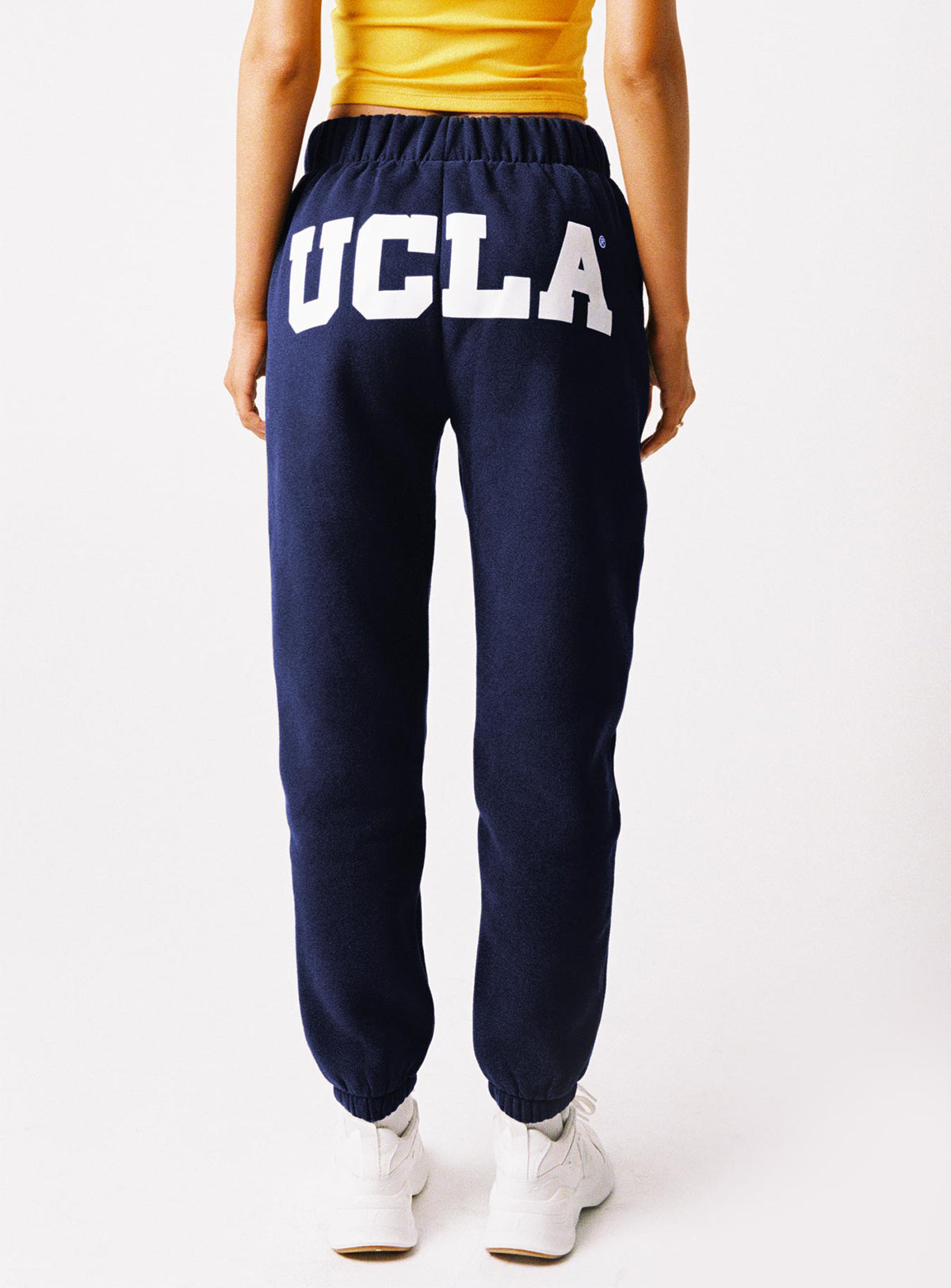 back view of model wearing Princess Polly UCLA Sweatpants Navy High Rise Pants Pants 