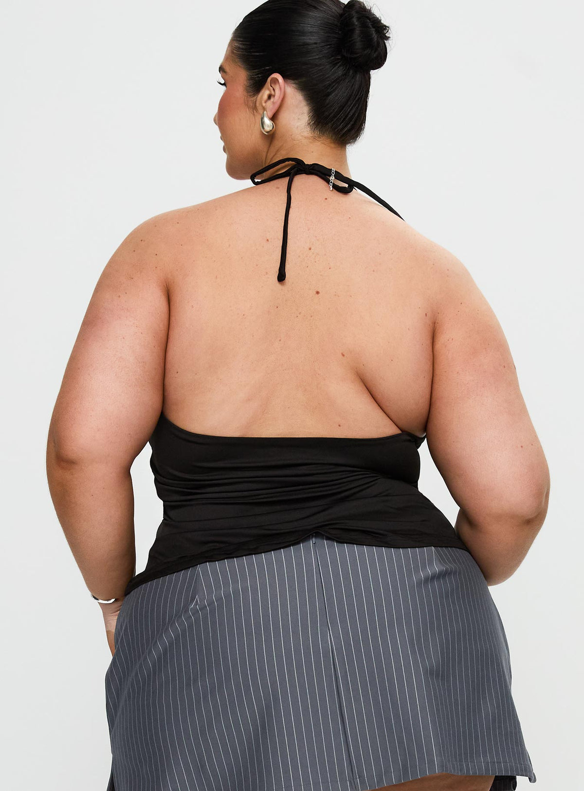 back view of model wearing Princess Polly Averee Halter Top Black Curve Sleeveless Plunger 