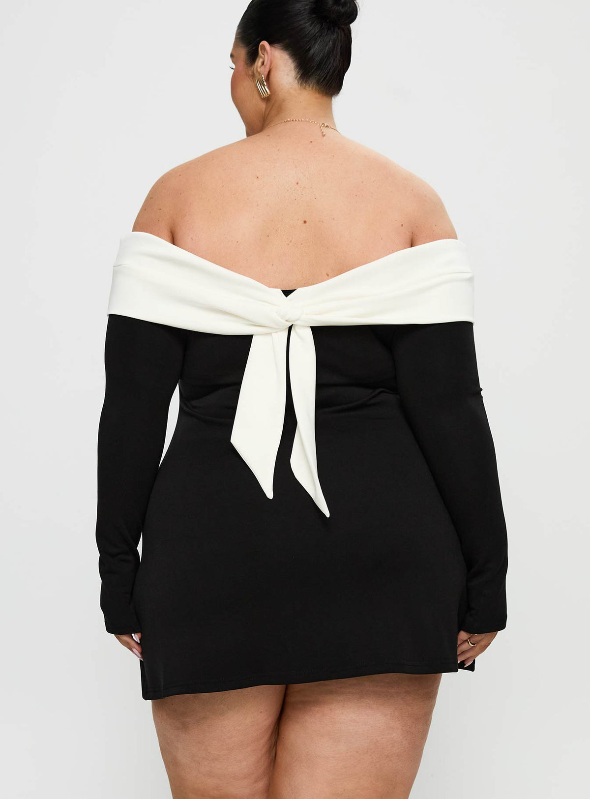 back view of model wearing Princess Polly Distractions Off The Shoulder Mini Dress Multi Curve High Neck 