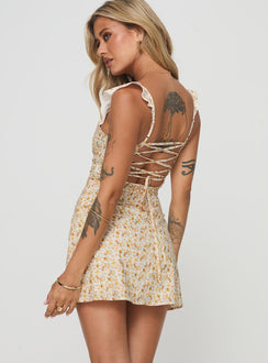 back view of model wearing Princess Polly Landon Mini Dress Yellow Floral Petite Scoop Neck 