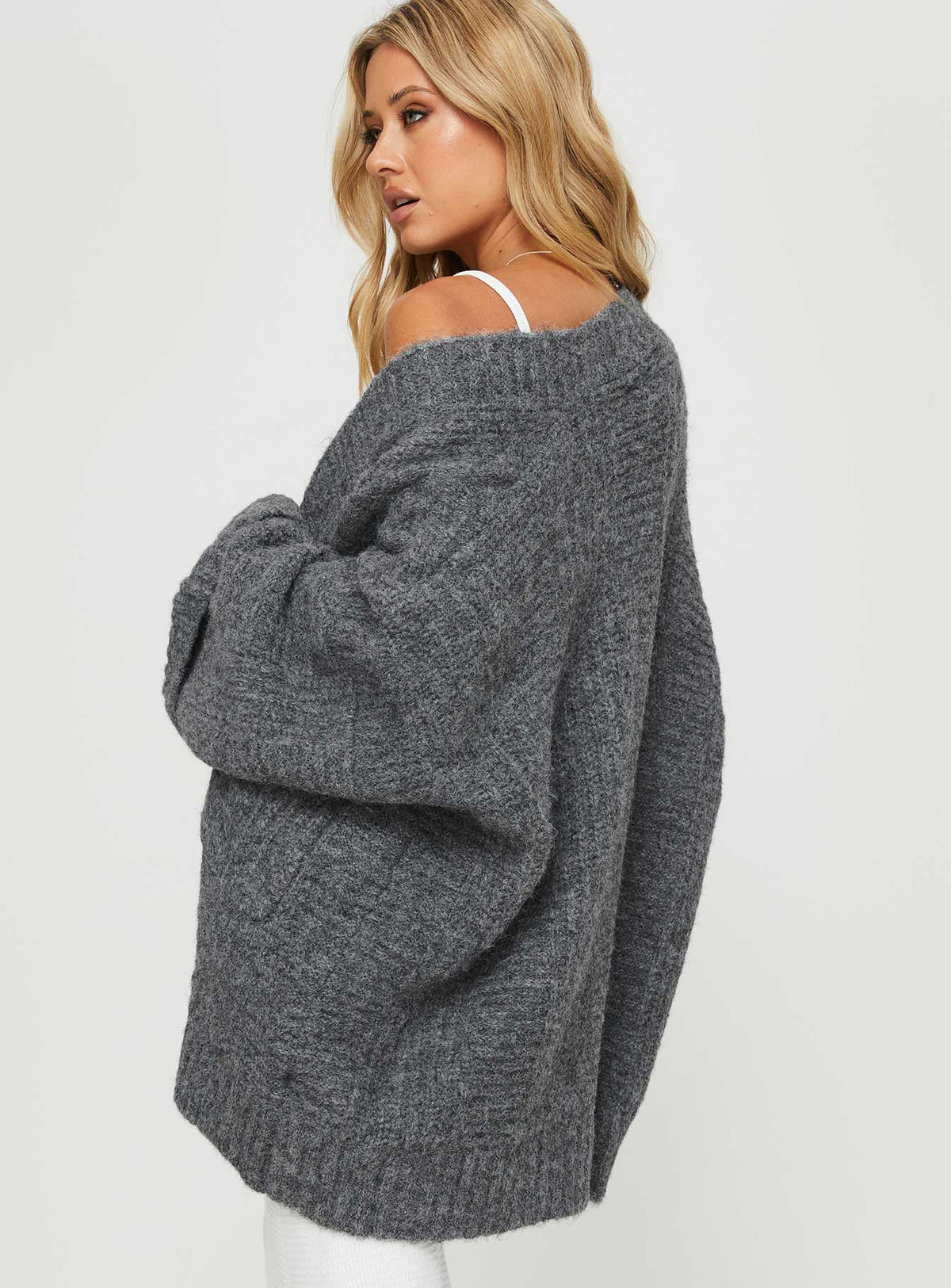 Designed with Paisleigh Cable Knit Cardigan Charcoal womens jumpers in long length back view of model wearing Princess Polly