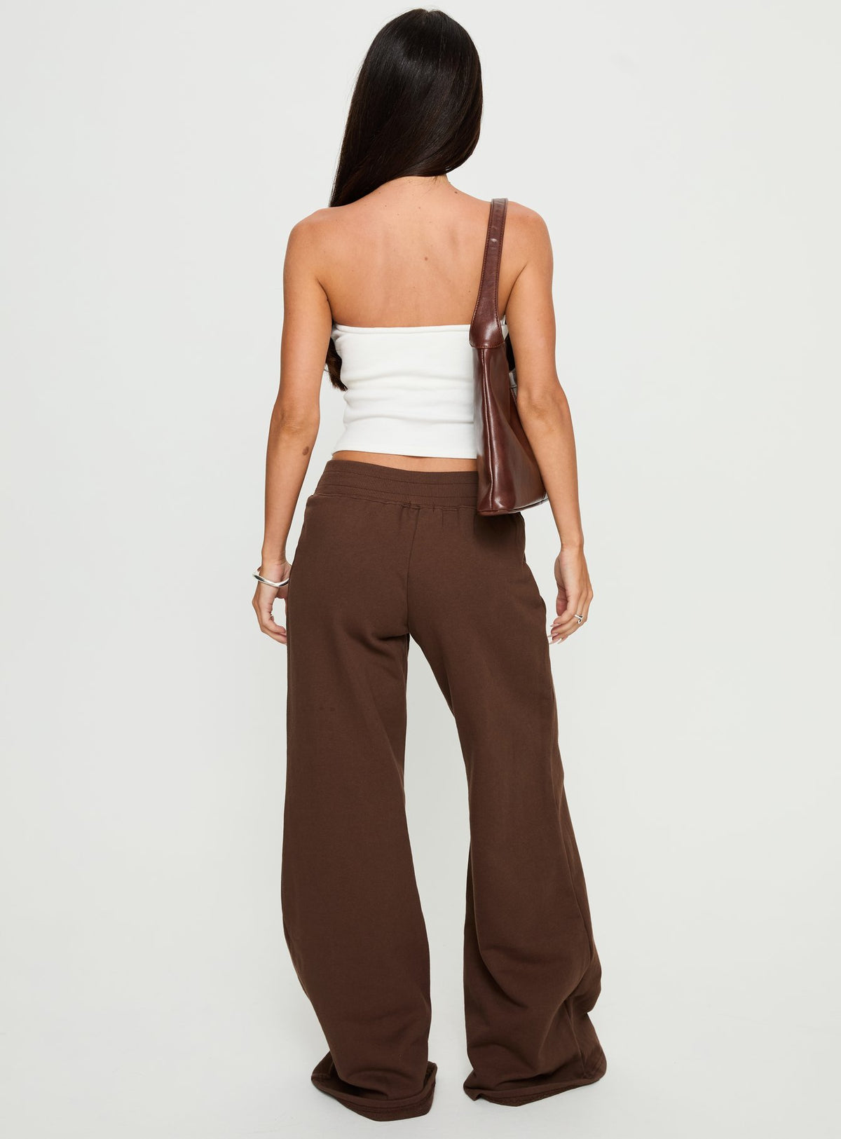 back view of model wearing Princess Polly Summits Flared Track Pants Chocolate High Rise Pants Pants 