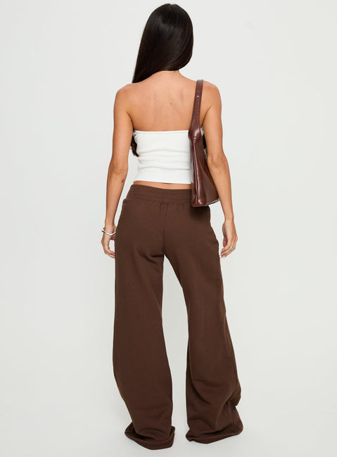 back view of model wearing Princess Polly Summits Flared Track Pants Chocolate High Rise Pants Pants 