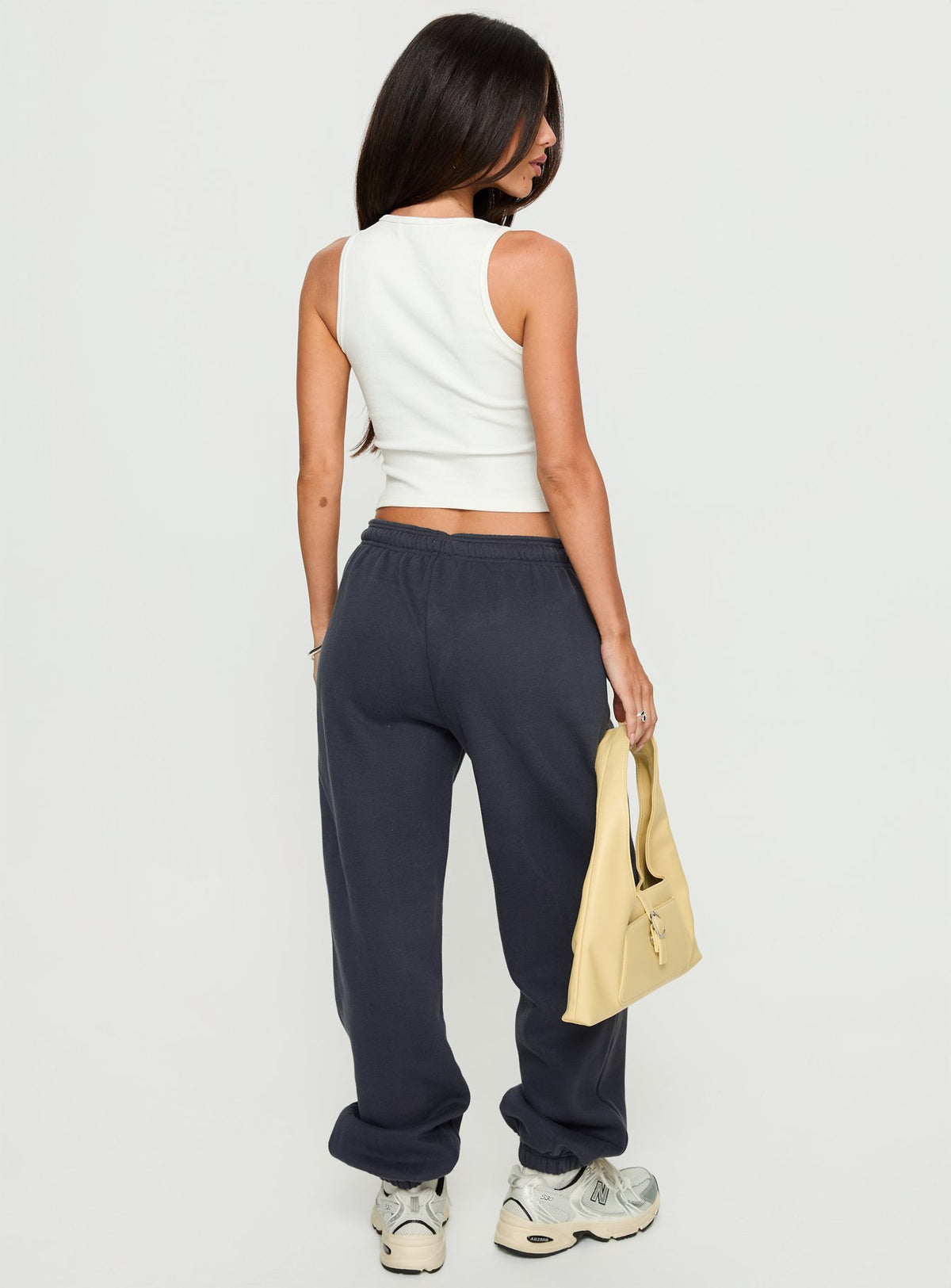 back view of model wearing Princess Polly Caspa Dream Fleece Oversized Ankle Cuff Jogger Navy High Rise Pants Pants 