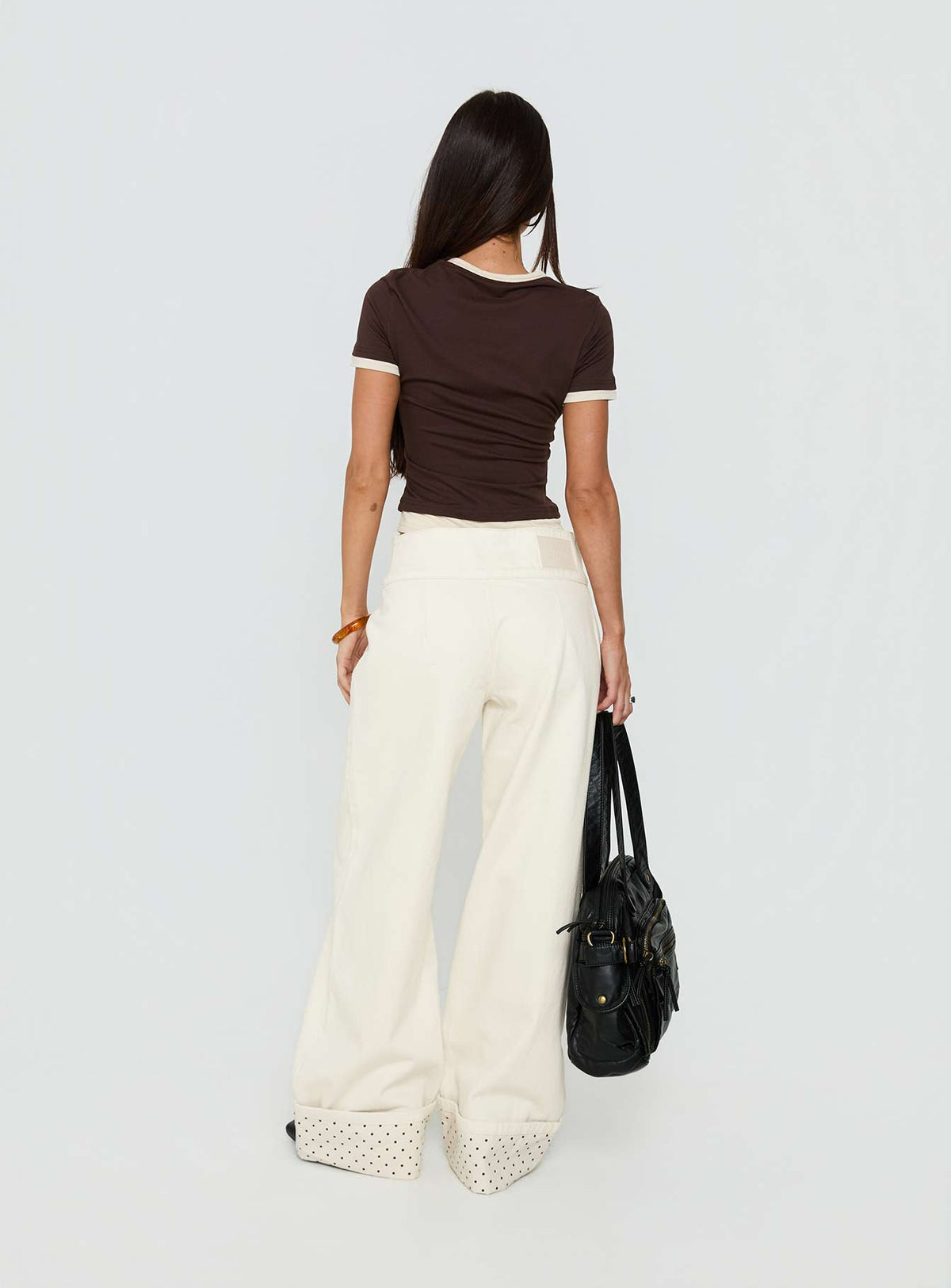 Presenting the Nikoletta Foldover Jeans Cream / Polka Petite womens-jeans with high-rise back view of model wearing Princess Polly