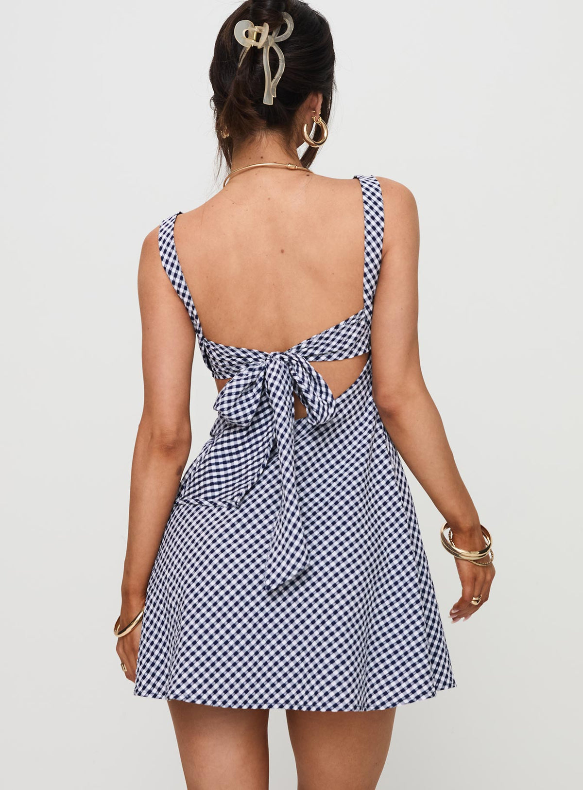 back view of model wearing Princess Polly Mcbeath Mini Dress Navy Check Sweetheart Neckline 