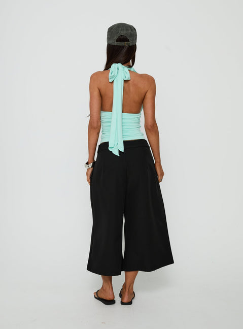 Presenting the Busy Busy Low Baggy Capri Pant Black in womens-regular-pants with low-rise back view of model wearing Princess Polly