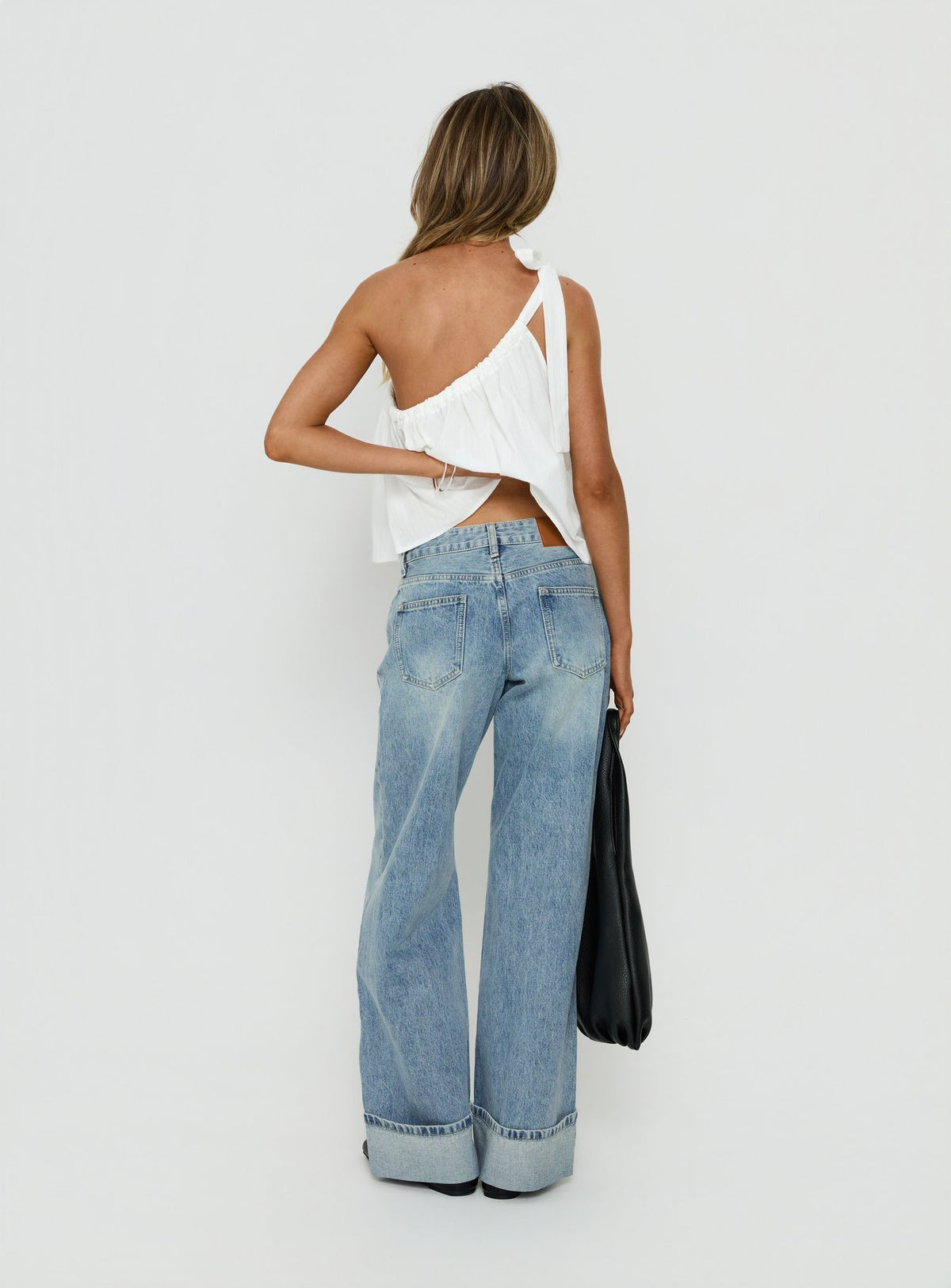 Displaying the Serenitia Mid Rise Relaxed Cuff Jeans Light Vintage Wash womens-jeans with mid-rise back view of model wearing Princess Polly