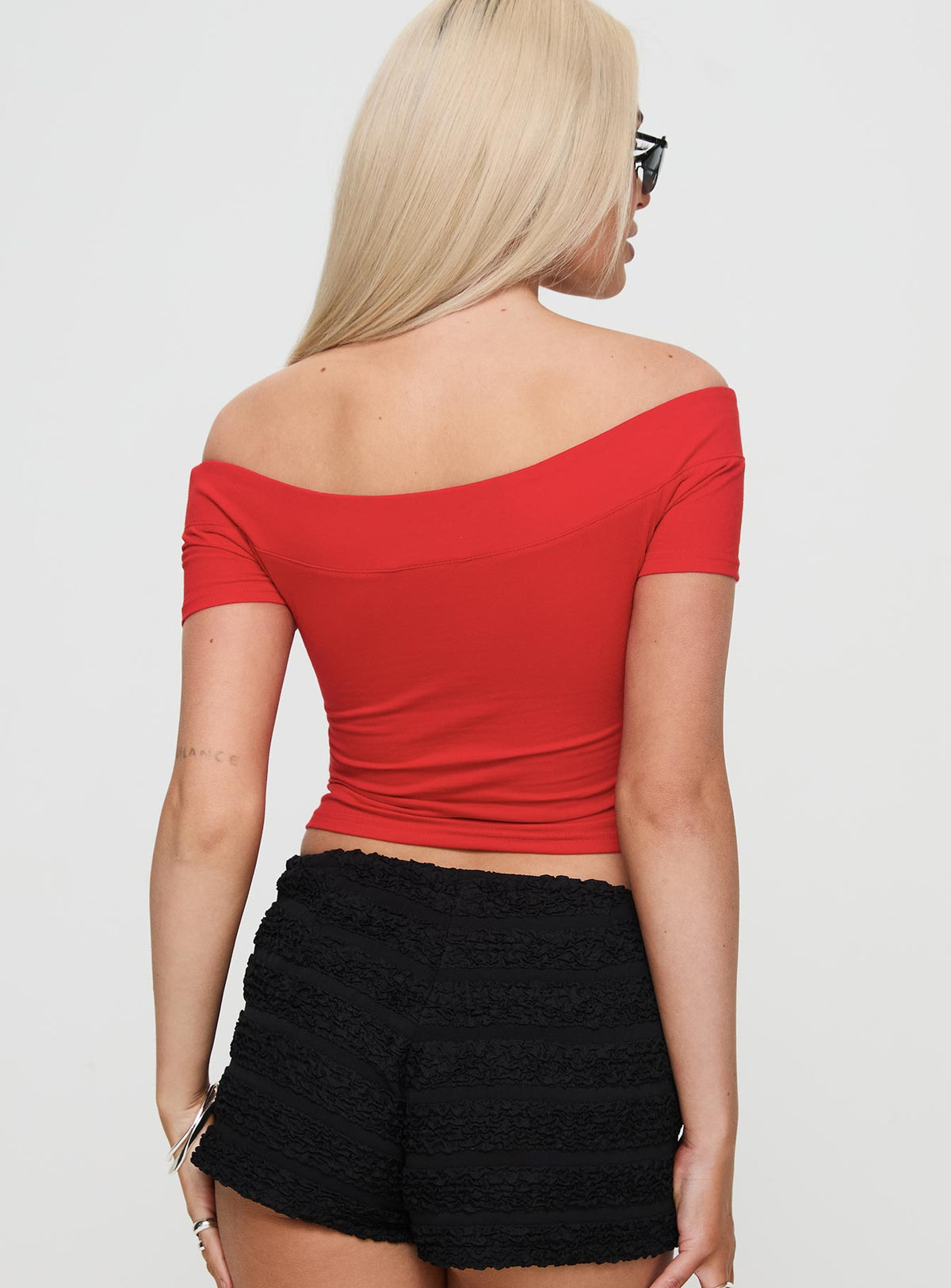 back view of model wearing Princess Polly Serendipia Off The Shoulder Graphic Top Red Short Sleeves straight 