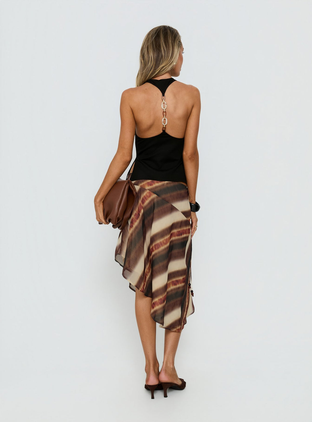 Presenting the Esmira Asymmetrical Midi Skirt Brown Stripe Petite in womens-skirts with relaxed fit and frayed hem back view of model wearing Princess Polly