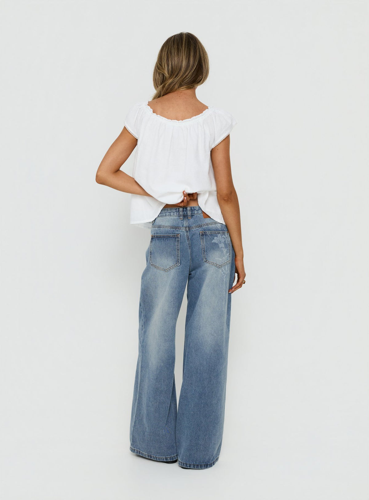 Johnni Floral Printed Low Rise Jeans Mid Wash womens-jeans back view of model wearing Princess Polly