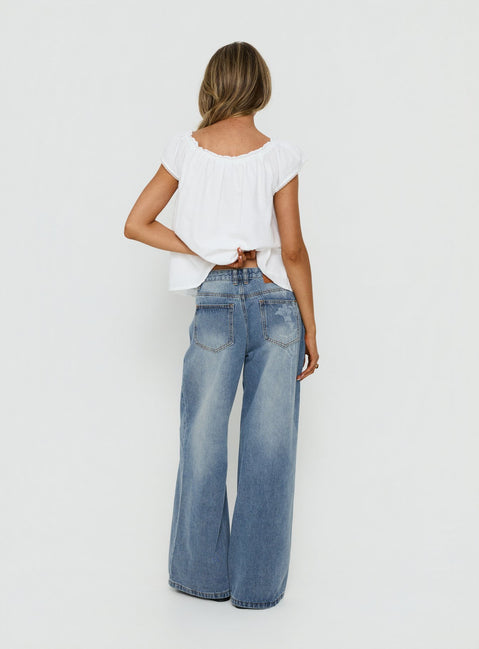 Johnni Floral Printed Low Rise Jeans Mid Wash womens-jeans back view of model wearing Princess Polly