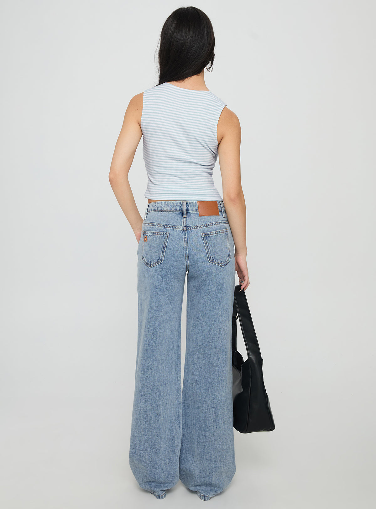 back view of model wearing Princess Polly Kadison Low Rise Straight Leg Jeans Mid Wash Blue Low Rise Jeans Jeans 