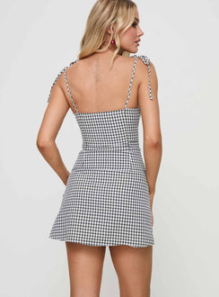 back view of model wearing Princess Polly Burkes Mini Dress Black Check Square Neck 