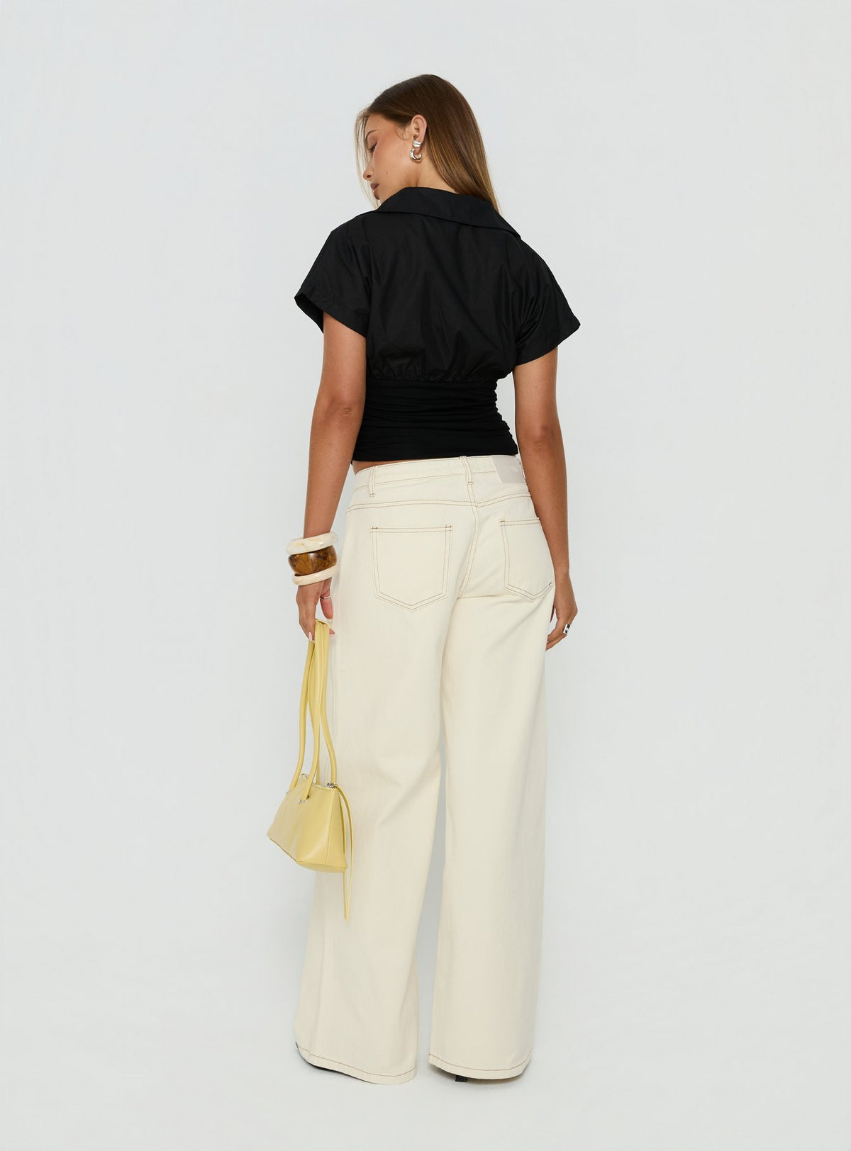 Designed with Ramos Low Rise Wide Leg Jeans in Cream womens-jeans featuring low-rise waist back view of model wearing