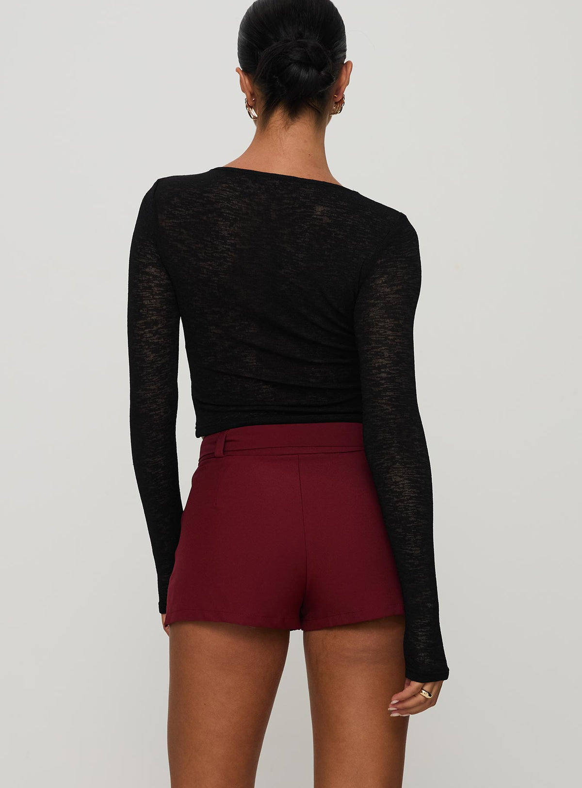 back view of model wearing Princess Polly Volley Mini Skort Cherry Red Tall High Waisted Shorts 
