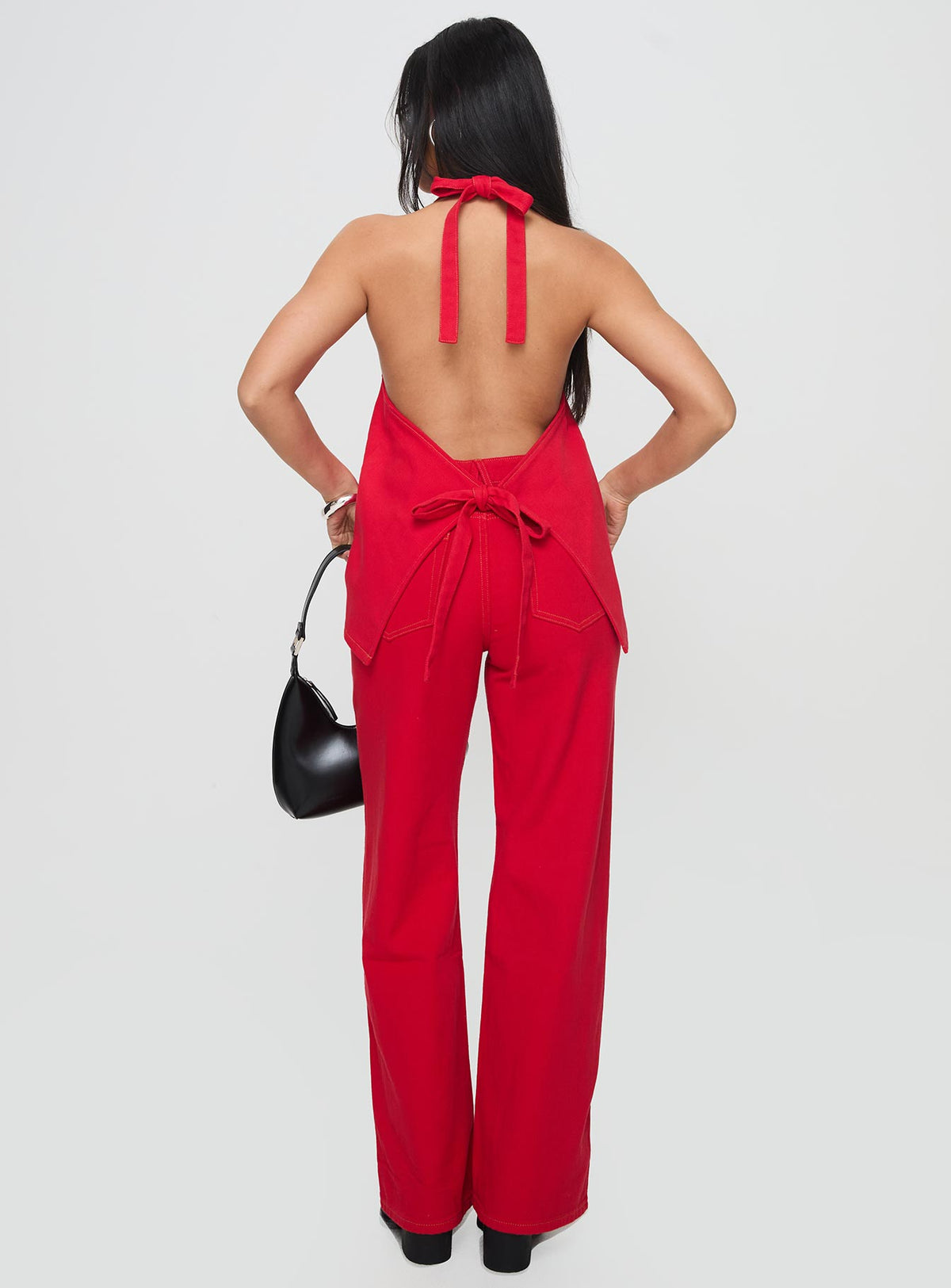 back view of model wearing Princess Polly Top Model Jeans Red Mid Rise Jeans Jeans 
