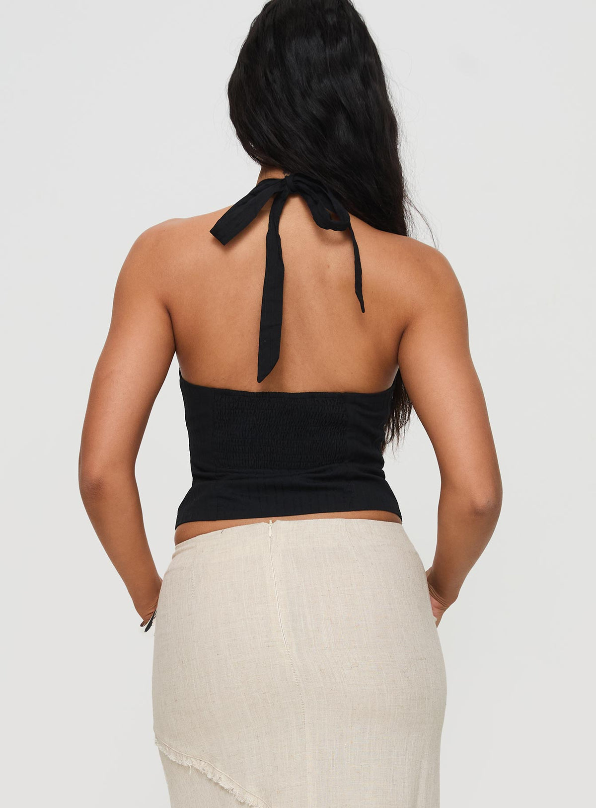 back view of model wearing Princess Polly Vayda Halter Top Black Sleeveless Plunger 