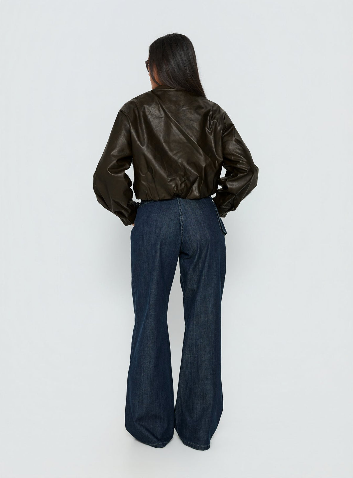 back view of model wearing Princess Polly Paltrow Mid Rise Wide Leg Cargo Jeans Dark Blue Wash Mid Rise Jeans Jeans 