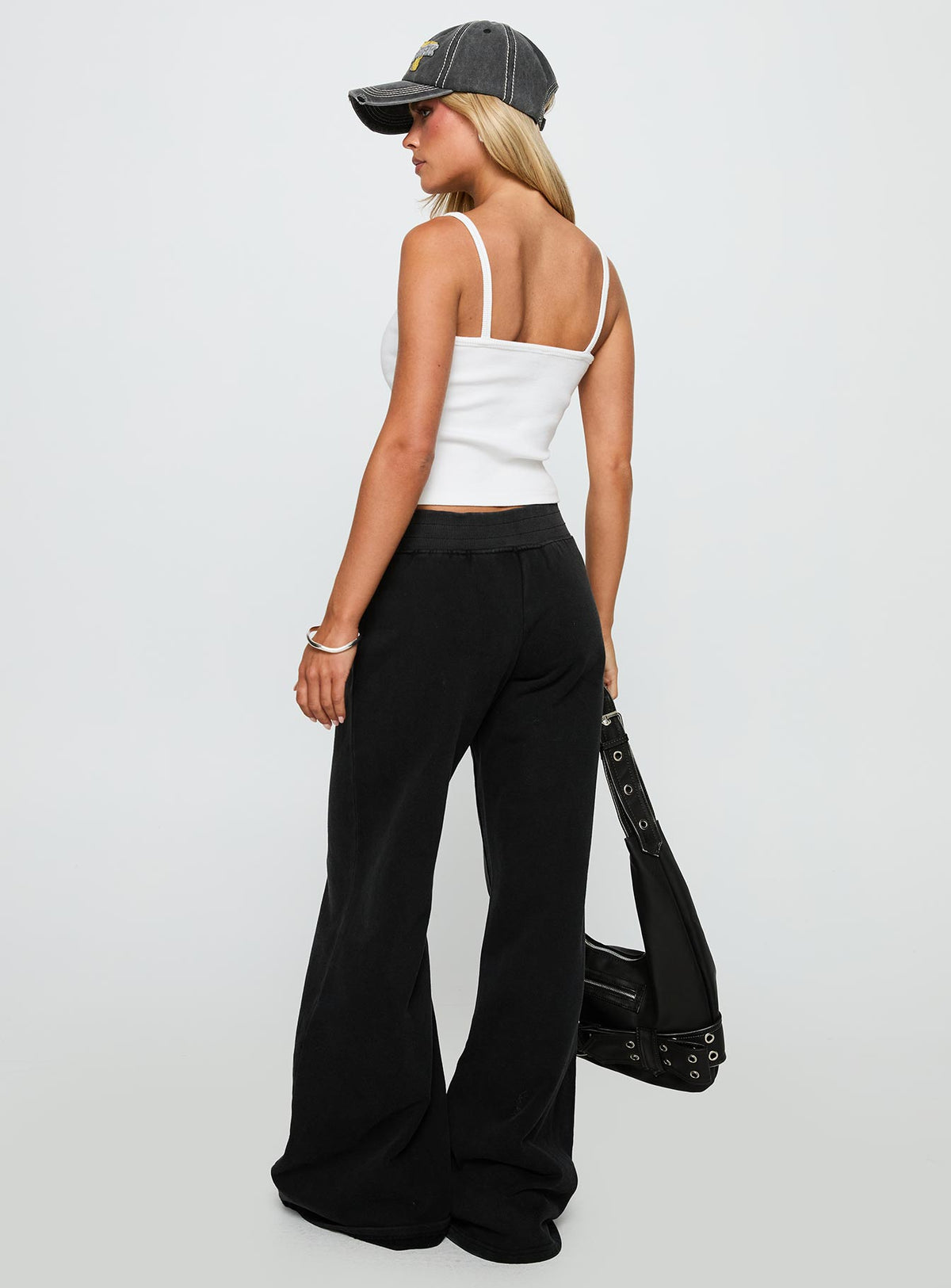back view of model wearing Princess Polly Summits Flared Track Pants Washed Black High Rise Pants Pants 