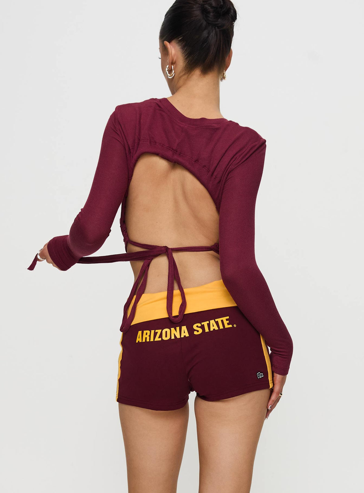 back view of model wearing Princess Polly ASU Foldover Shorts Maroon Low Rise Shorts 