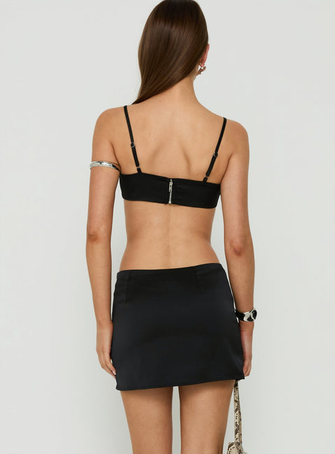 Displaying the Edeniah Satin Mini Skirt Black womens-skirts in mini length back view of model wearing