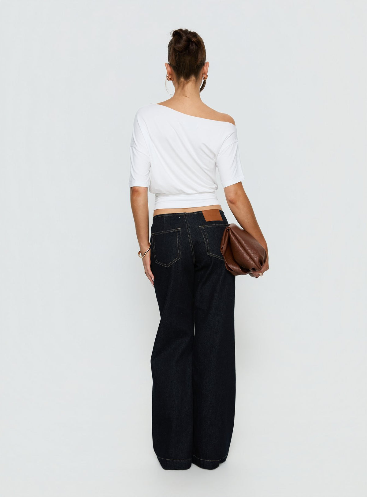 Highlighting Buenos No Waist Low Rise Straight Leg Jeans in Raw Denim womens-jeans featuring low-rise waist back view of model wearing