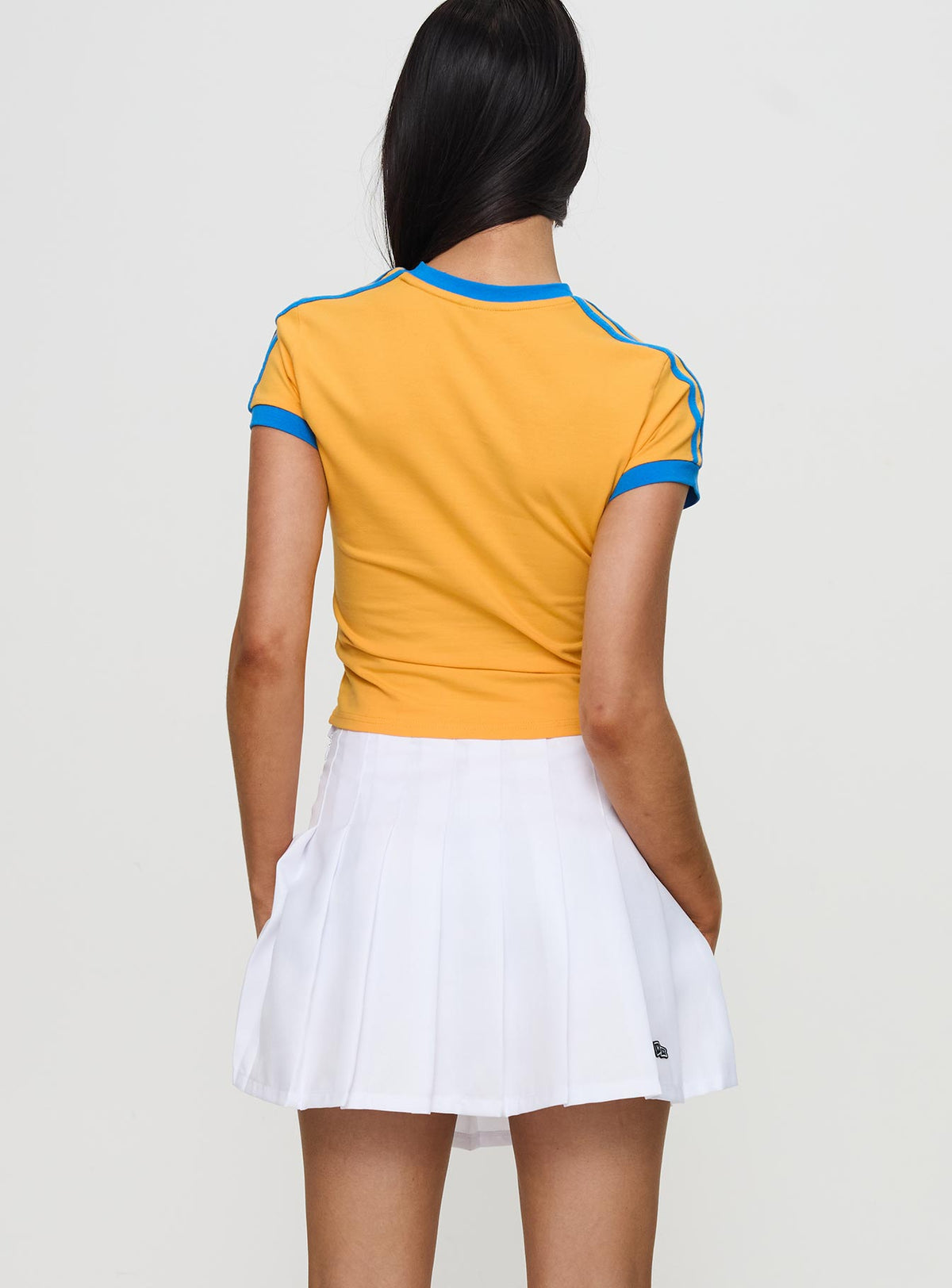 back view of model wearing Princess Polly UCLA Tennis Skort White Skirts 