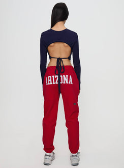 Highlighting U of A Sweatpants Red in womens regular pants with mid-rise and graphic print, back view of model wearing