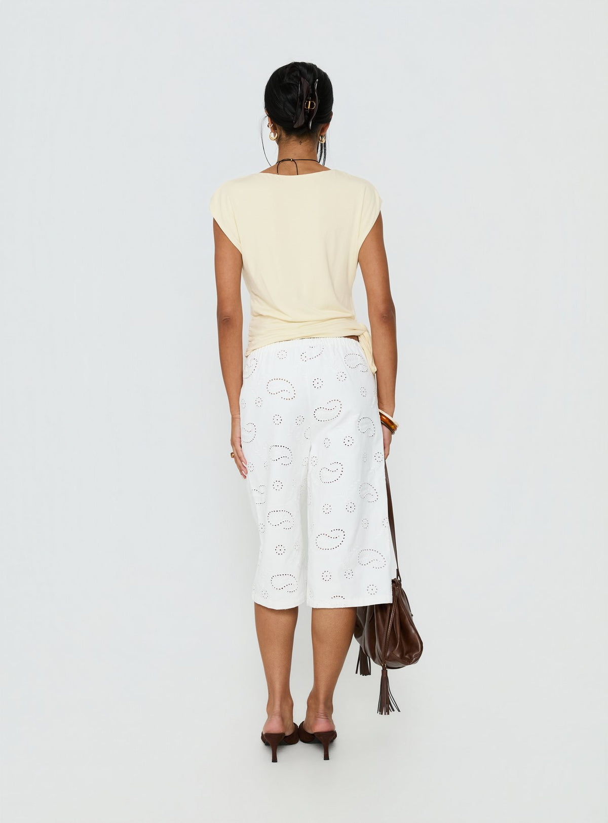 back view of model wearing Princess Polly Roda Anglaise Longline Shorts White Mid Rise Pants Pants 