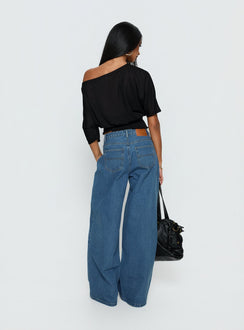 back view of model wearing Princess Polly Naylor Mid Rise Wide Leg Jeans Mid Blue Wash Mid Rise Jeans Jeans 