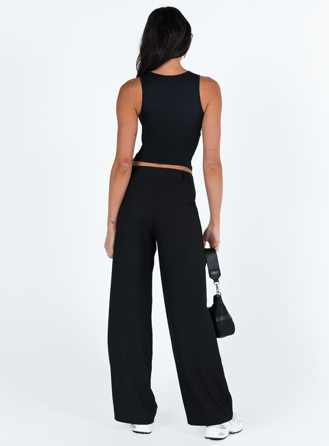 back view of model wearing Princess Polly Archie Low Rise Pants Black Petite Mid Rise Pants Pants 