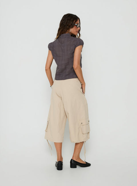 Presenting the Relaxer 3/4 Cargo Pants Beige in womens regular pants with mid-rise back view of model wearing Princess Polly