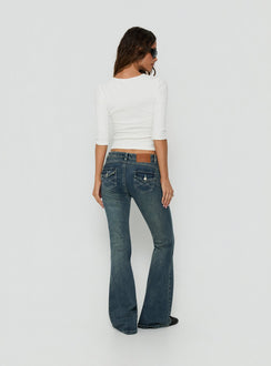 Showcasing the Clynee Ultra Low Rise Bootleg Jeans Dirty Blue in womens-jeans back view of model wearing Princess Polly