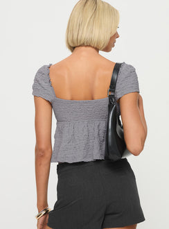 back view of model wearing Princess Polly Kellan Cap Sleeve Top Blue Short Sleeves Plunger 