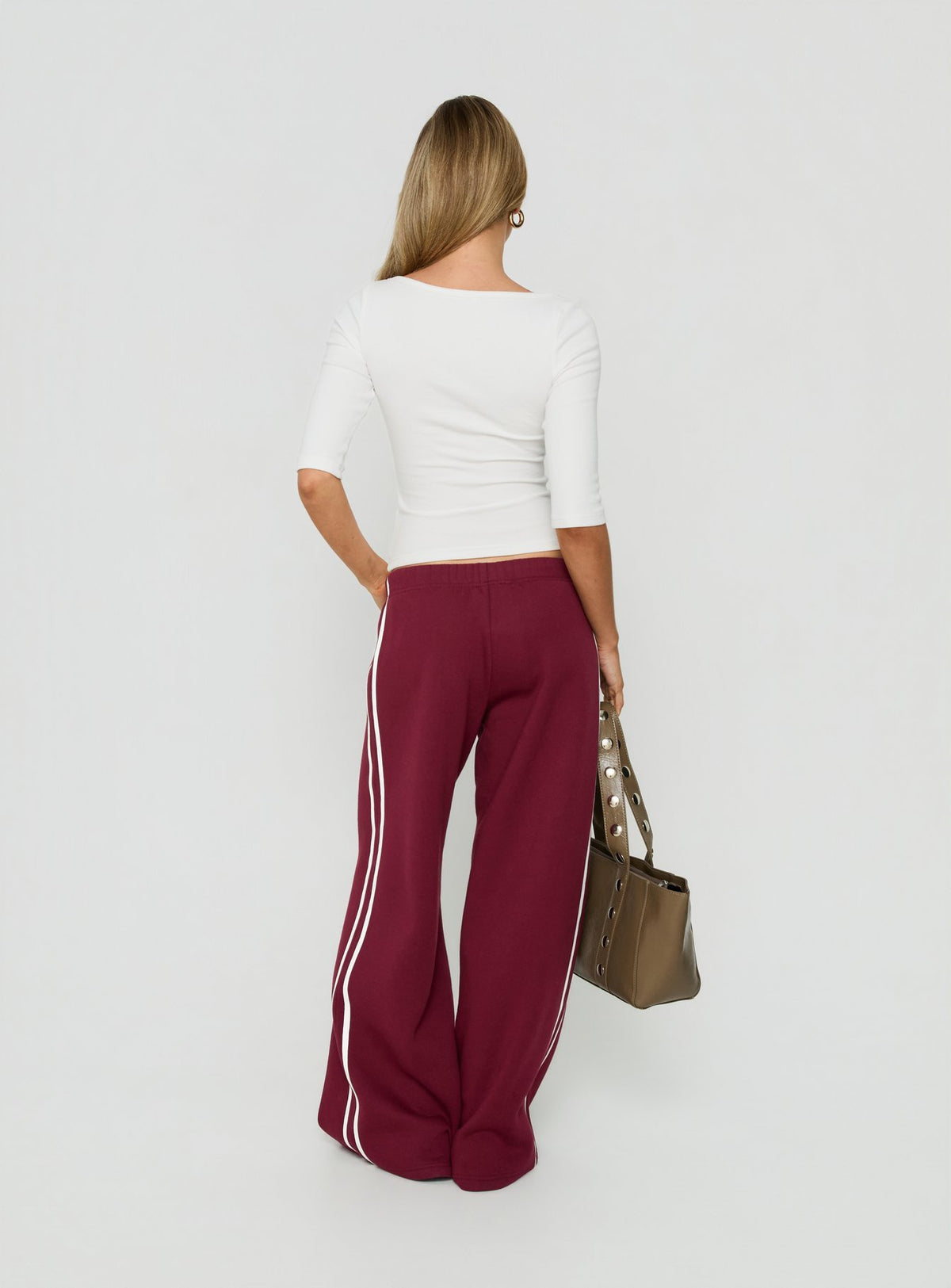 Presenting the Kennah Wide Leg Sweat Pants Cherry in womens-regular-pants with mid-rise styling back view of model wearing Princess Polly