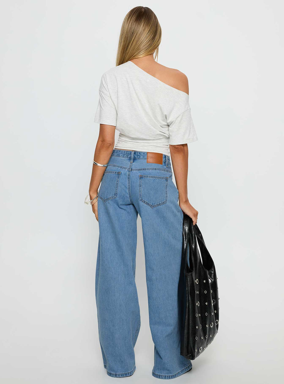 back view of model wearing Princess Polly Supercut Low Rise Baggy Pleat Jeans Light Blue Wash Low Rise Jeans Jeans 