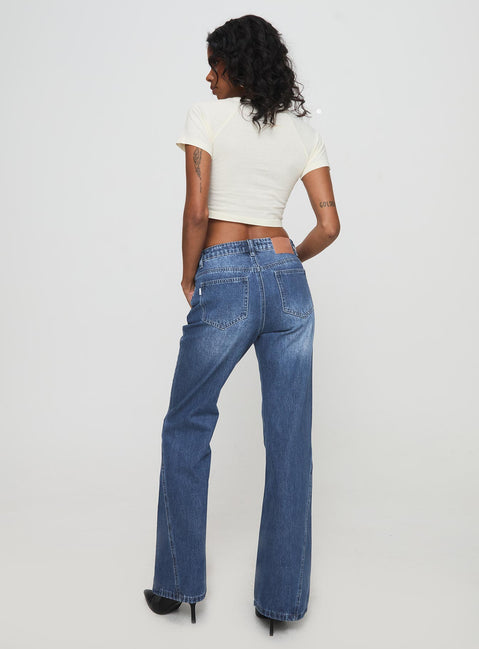 back view of model wearing Princess Polly Leslee Mid Rise Flare Jean Mid Wash Blue Mid Rise Jeans Jeans 