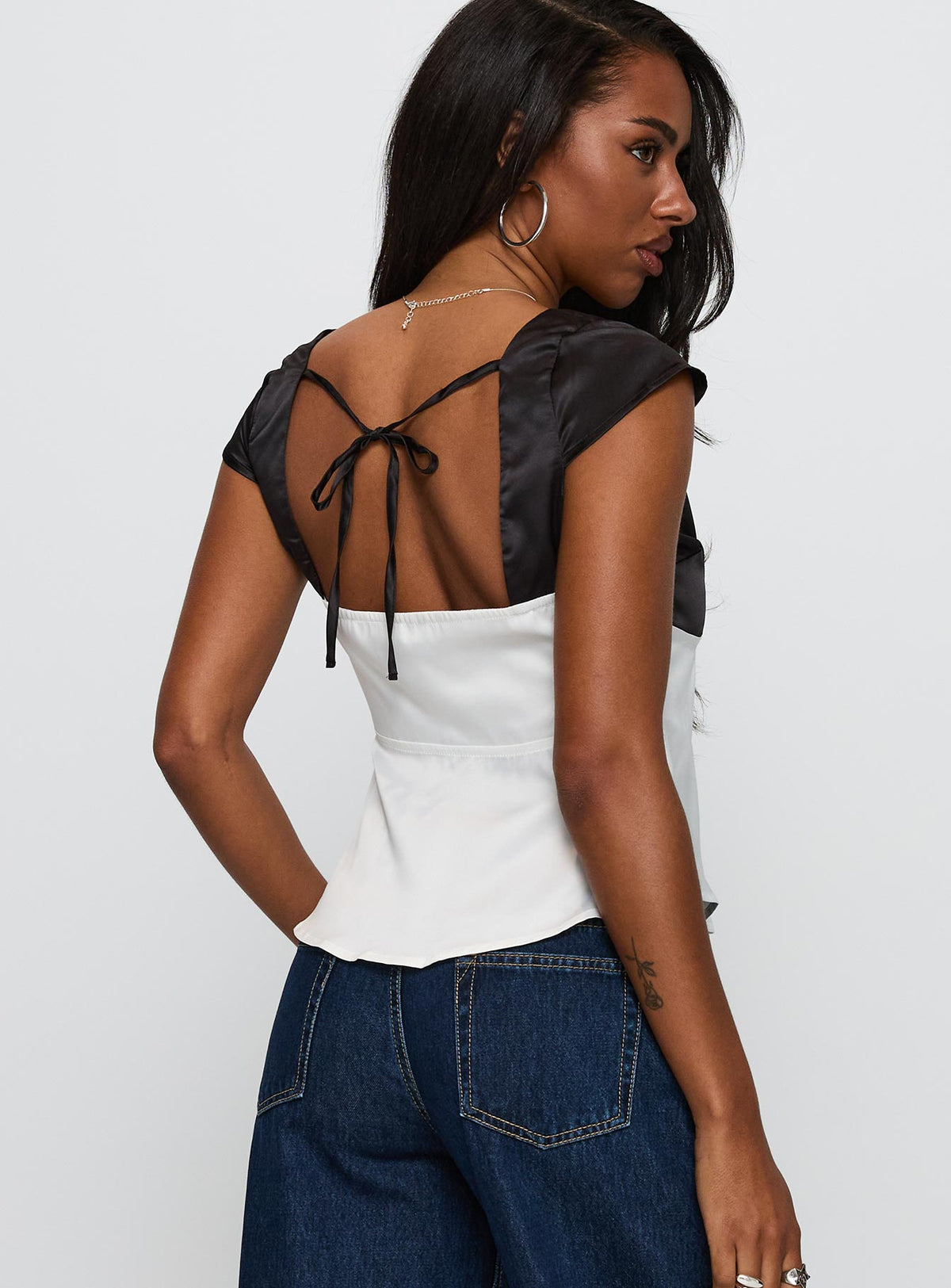 back view of model wearing Princess Polly Think About It Cap Sleeve Top Black / White Short Sleeves V-Neck 