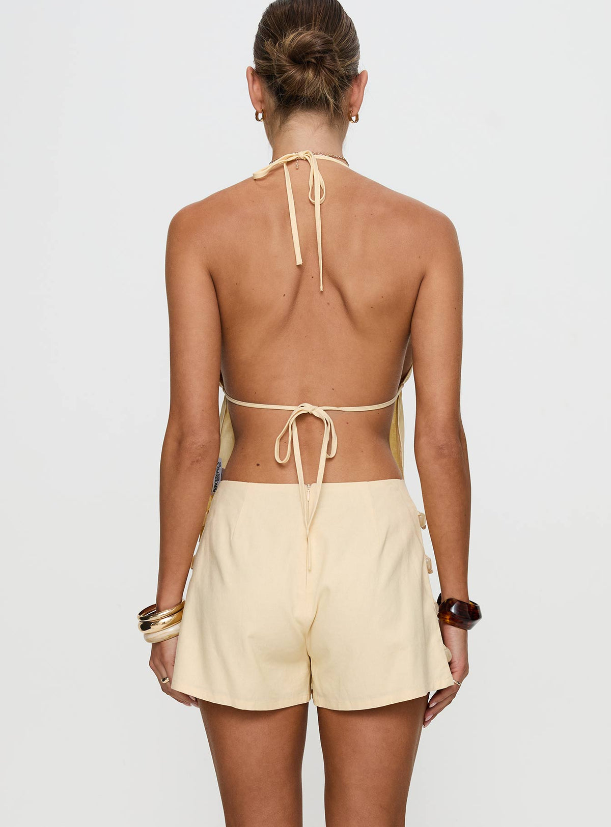 back view of model wearing Princess Polly Solid Gold Shorts Lemon High Waisted Shorts 